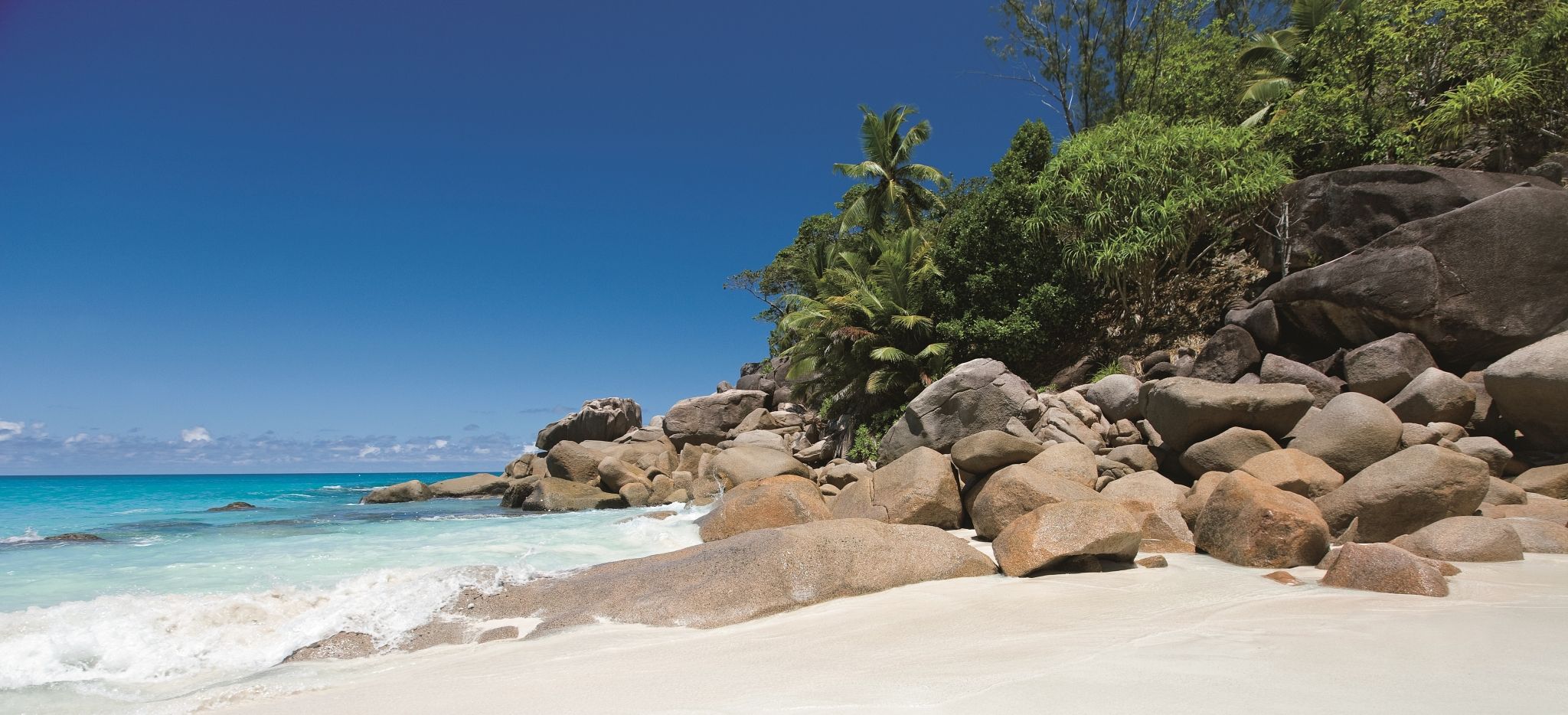 Ein weißer Sandstand mit Felsen, Anse Georgette, Praslin, Seychellen