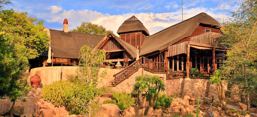 Der Garten der Fevertree Lodge in Südafrika, mit dem Hauptgebäude im Hintergrund